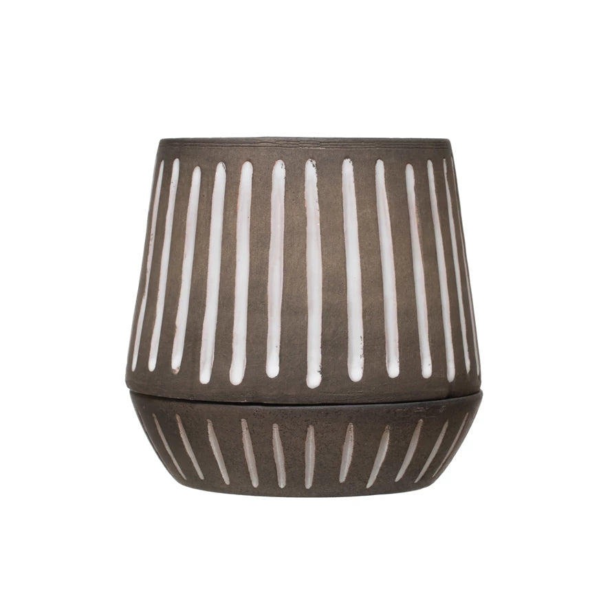 A brown terracotta pot with white stripes pattern, including a saucer, displayed against a white background.